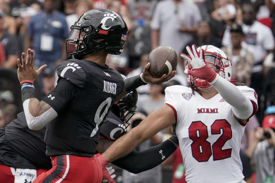 Cincinnati quarterback Desmond Ridder (9) throws a pass during the first half an NCAA college football game against Miami (Ohio), Saturday, Sept. 4, 2021, in Cincinnati. (AP Photo/Jeff Dean)