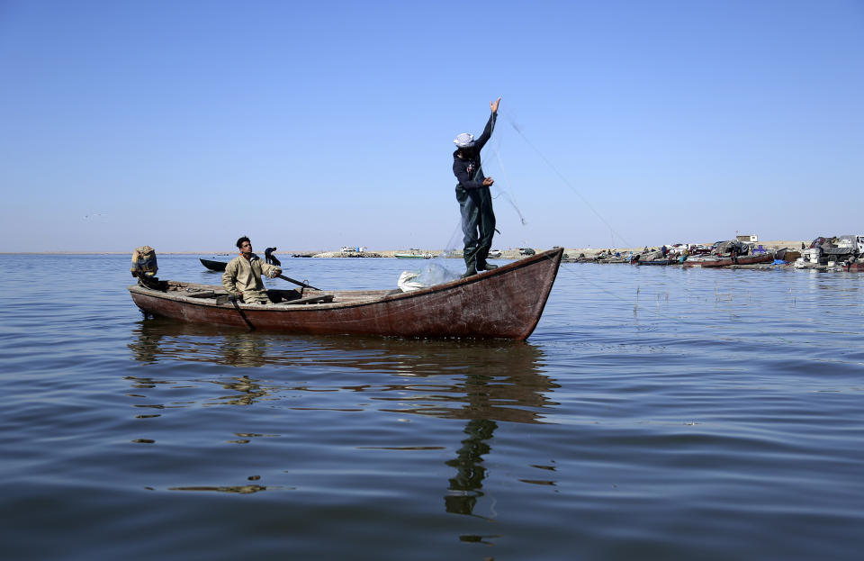 Fishermen pull n their nets in the salty waters of Razzaza Lake, also known as Lake Milh, Arabic for salt, in the Karbala governorate of Iraq, Feb. 14, 2022. Feb. 14, 2022. Hundreds of families used to rely on fishing in the lake for their livelihood. Now the number of dead fish that turn up is bigger than the number of live fish they can catch. (AP Photo/Hadi Mizban)