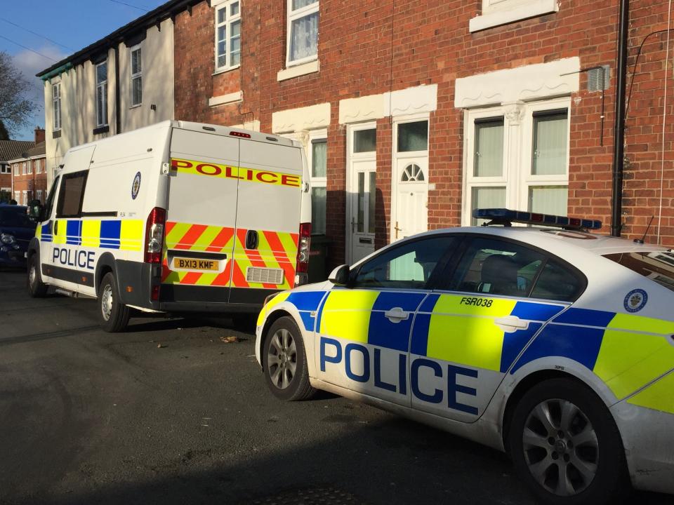 Police vehicles at the scene in James Street, Bilston, Wolverhampton, after a woman’s body was found at her home. A 40-year-old man has been arrested on suspicion of murder.