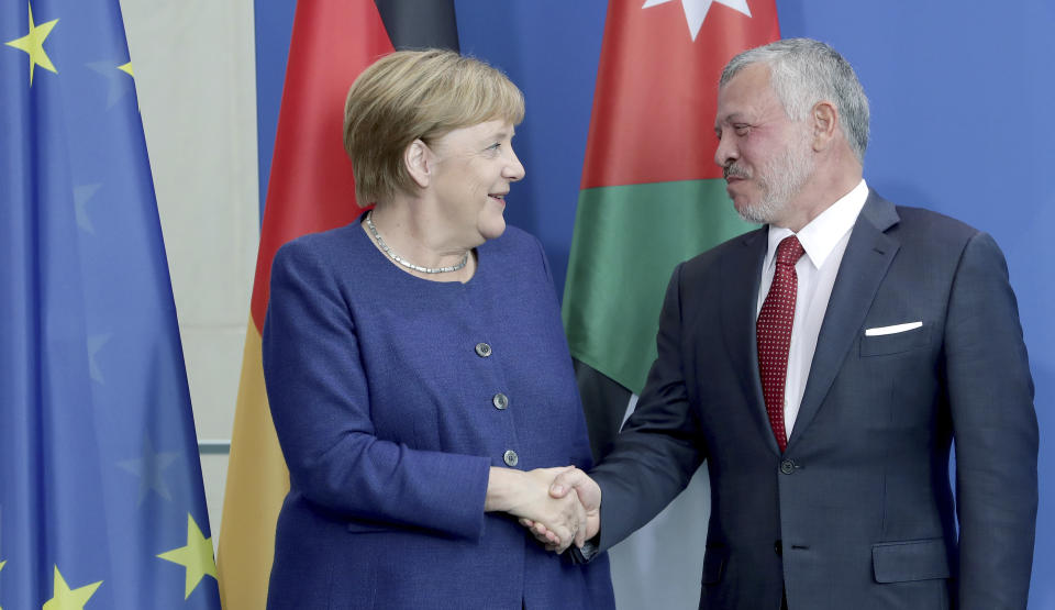 German Chancellor Angela Merkel, left, and Jordan's King Abdullah II, right, shake hands after a joint press conference as part of a meting at the Chancellery in Berlin, Germany, Tuesday, Sept. 17, 2019. (AP Photo/Michael Sohn)