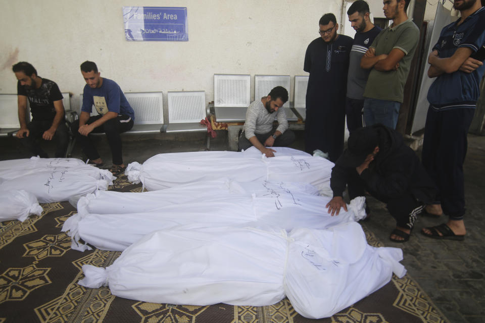 Palestinians gather around the bodies of their relatives who were killed by an Israeli airstrike, at the hospital in Rafah, Gaza Strip, Friday, Oct. 13, 2023. (AP Photo/Hatem Ali)