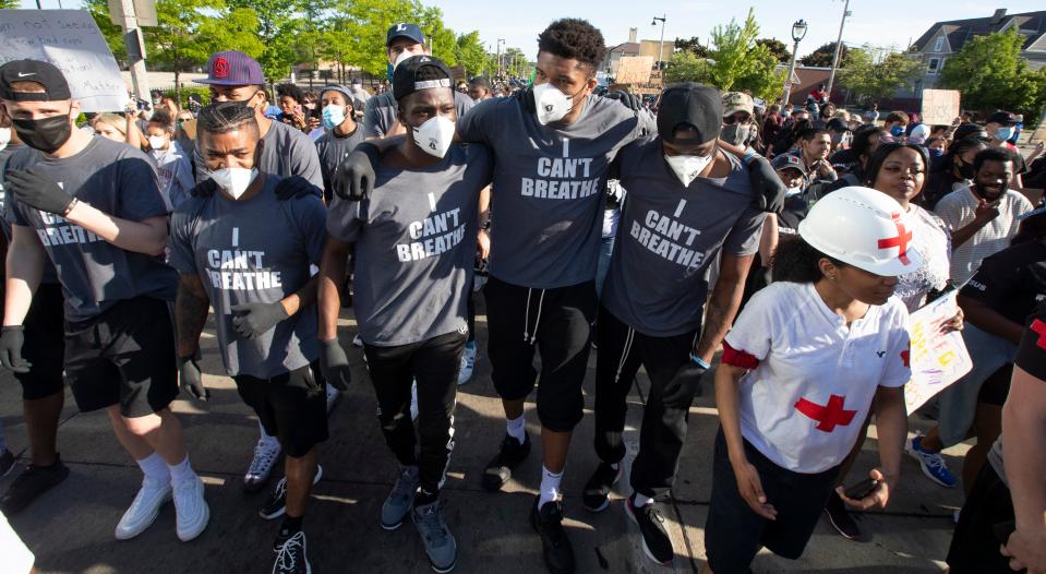 Bucks star Giannis Antetokounmpo, fourth from left, and some of his teammates march with a group protesting racial injustice in June 2020 in Milwaukee.