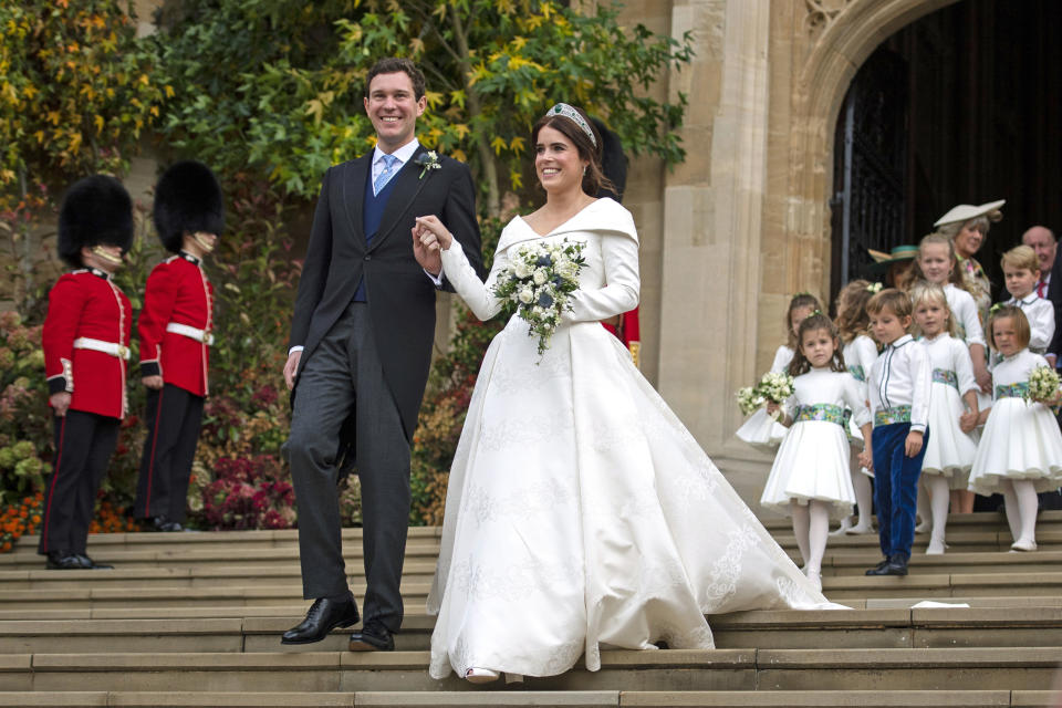 <p>Jack Brooksbank and Princess Eugenie leave St George’s Chapel at Windsor Castle on their wedding day on October 12, 2018 (Getty) </p>