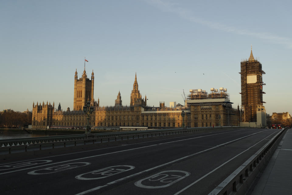 An almost empty Westminster Bridge normally a very busy river crossing as the sun rises in London, Tuesday, March 24, 2020. Britain's Prime Minister Boris Johnson on Monday imposed its most draconian peacetime restrictions due to the spread of the coronavirus on businesses and gatherings, health workers begged for more gear, saying they felt like "cannon fodder." For most people, the new coronavirus causes only mild or moderate symptoms, such as fever and cough. For some, especially older adults and people with existing health problems, it can cause more severe illness, including pneumonia. (AP Photo/Matt Dunham)