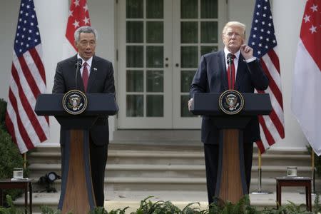 Singapore's Prime Minister Lee Hsien Loong and U.S. President Donald Trump give joint statements in the Rose Garden of the White House in Washington, U.S., October 23, 2017. REUTERS/Joshua Roberts