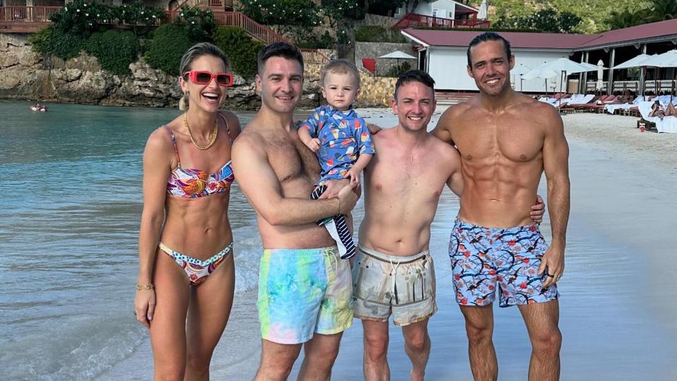 Vogue Williams showcasing abs in floral bikini with tanned and muscular husband Spencer Matthews on beach holiday