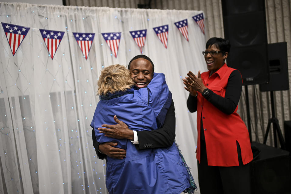 Brooklyn Center Mayor Mike Elliott embraces Sue Low, of Maple Grove, after Elliot's inauguration ceremony, Wednesday, Jan. 2, 2019 at the Brooklyn Center Community Center, in Brooklyn Center, Minn. "He's just an amazing guy and we're really excited for Brooklyn Center," said Low, who's known Elliott since he was in high school and has worked alongside him on various committees over the years. Elliott, who emigrated from Liberia as a child, is finding just how difficult it is to turn the page on the nation’s racial history as he handles the fallout from a police shooting. (Aaron Lavinsky/Star Tribune via AP)