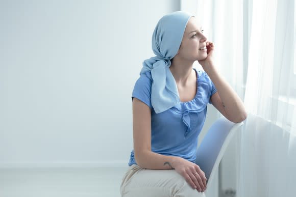 Female cancer patient sitting on a chair.