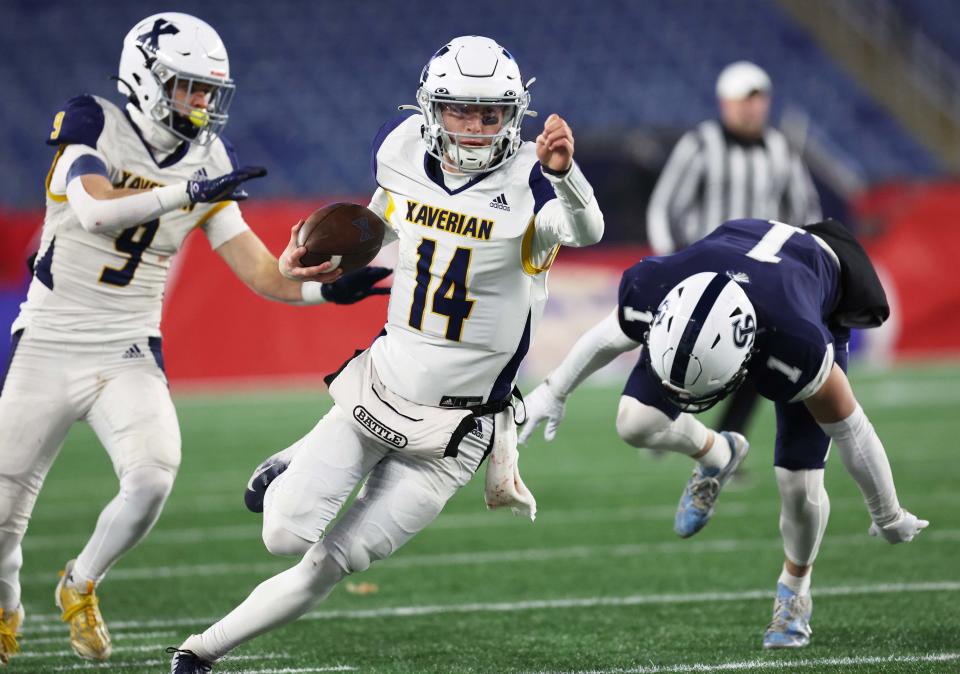 Xaverian quarterback Henry Hasslebeck runs past St. John's Prep defender Grayson Ambrosh during the Division 1 state title game at Gillette Stadium on Wednesday, Nov. 29, 2023.