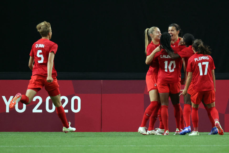 Canada's forward Christine Sinclair (3R) celebrates with teammates scoring the opening goal during the Tokyo 2020 Olympic Games women's group E first round football match between Japan and Canada at the Sapporo Dome in Sapporo on July 21, 2021. (Photo by ASANO IKKO / AFP) (Photo by ASANO IKKO/AFP via Getty Images)