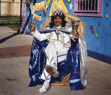 In this 2001 image released by The Historic New Orleans Collection, Ernie K-Doe poses outside of his Mother-In-Law Lounge during Jazz Fest in New Orleans. A new book published by the Historic New Orleans Collection, "Enie K-Doe: The R&B Emperor of New Orleans," by Ben Sandmel, captures the quirks and talent of one of New Orleans' most celebrated and eccentric entertainers, his ups and downs and the era that shaped him. (AP Photo/The Historic New Orleans Collection, Pat Jolly)