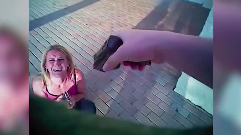 When the woman fails to comply, the officer takes out his taser and threatens her with it. Photo: Pasco County Sheriff