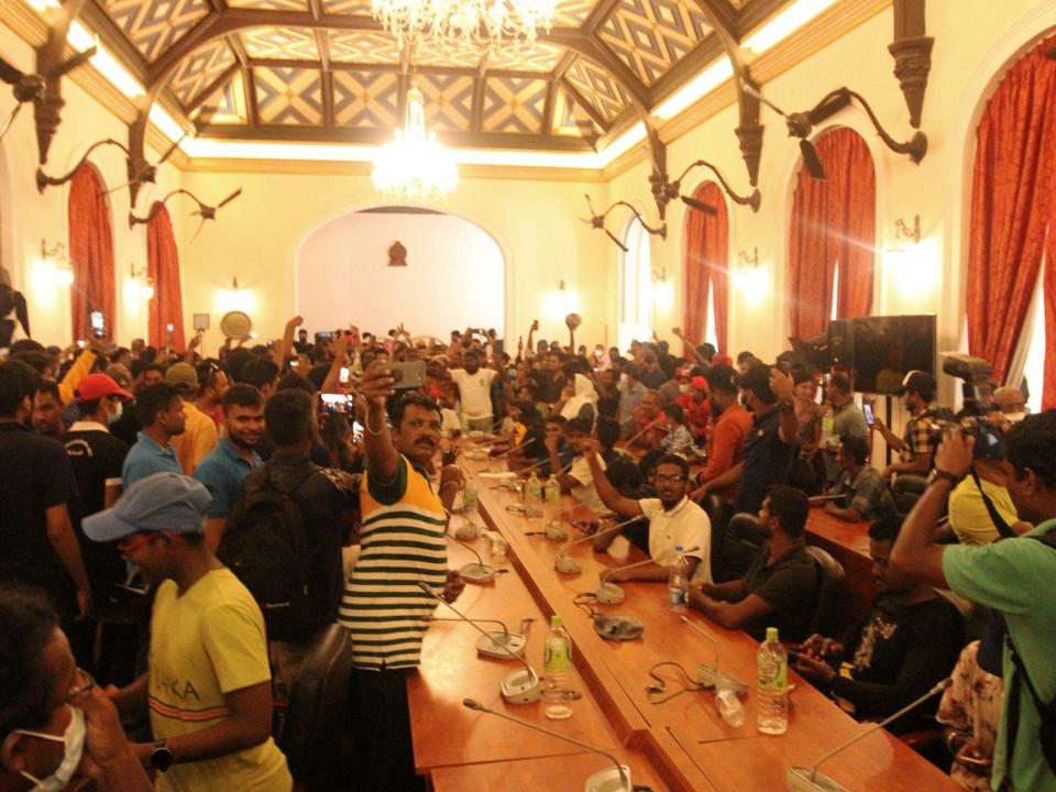 Protesters crowd inside the dining hall of the official residence of Sri Lanka's President, in Colombo, on July 10.,