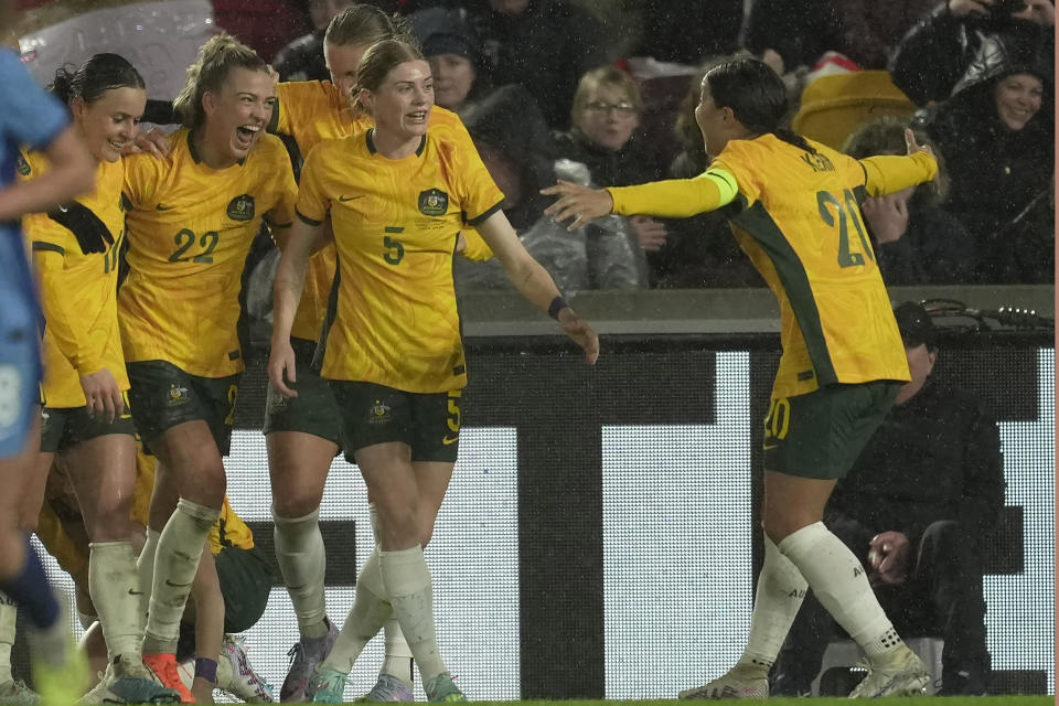 Australia's Charlotte Grant, second left, celebrates the second goal with her teammates after scoring against England during the women's international friendly soccer match between England and Australia at the Gtech Community Stadium in London, England, Tuesday, April 11, 2023. (AP Photo/Kin Cheung)