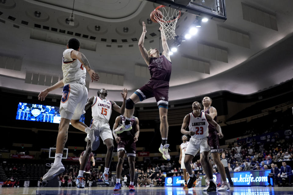Freed-Hardeman forward Hunter Scurlock (3) puts up a shot during the first half of the NAIA men's national championship college basketball game against Langston, Tuesday, March 26, 2024, in Kansas City, Mo. (AP Photo/Charlie Riedel)