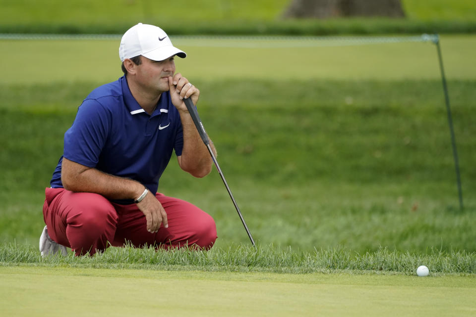 Patrick Reed, of the United States, checks his lie on the 17th green during the first round of the US Open Golf Championship, Thursday, Sept. 17, 2020, in Mamaroneck, N.Y. (AP Photo/Charles Krupa)