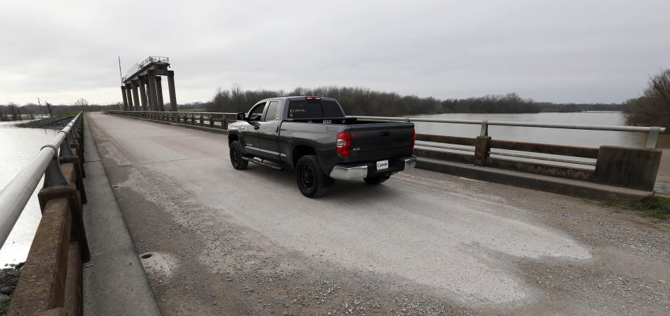 A truck passes on top of the levee at the Steele Bayou Drainage Structure in Warren County, Miss., as water from recent rainfalls rises on both sides in this Friday, March 1, 2019 photograph. As Mississippi River backwaters in the Eagle Lake area are at flood level and are projected to rise even higher, it is causing limited access to residents by emergency vehicles. The levee protects thousands of square miles of the Delta region from even worse flooding by the Mississippi River. (AP Photo/Rogelio V. Solis)