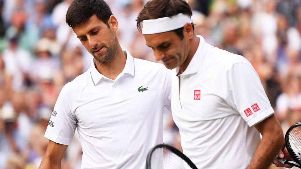 Novak Djokovic and Roger Federer embrace after their epic Wimbledon final. (Photo by LAURENCE GRIFFITHS/AFP/Getty Images)