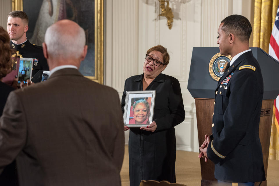 The Rev. Sharon Risher holds a photo of her mother, Ethel Lance, prior to remarks by President Barack Obama about federal gun control in the East Room of the White House in Washington on Jan. 5, 2016. (Photo: Ken Cedeno/Corbis via Getty Images)