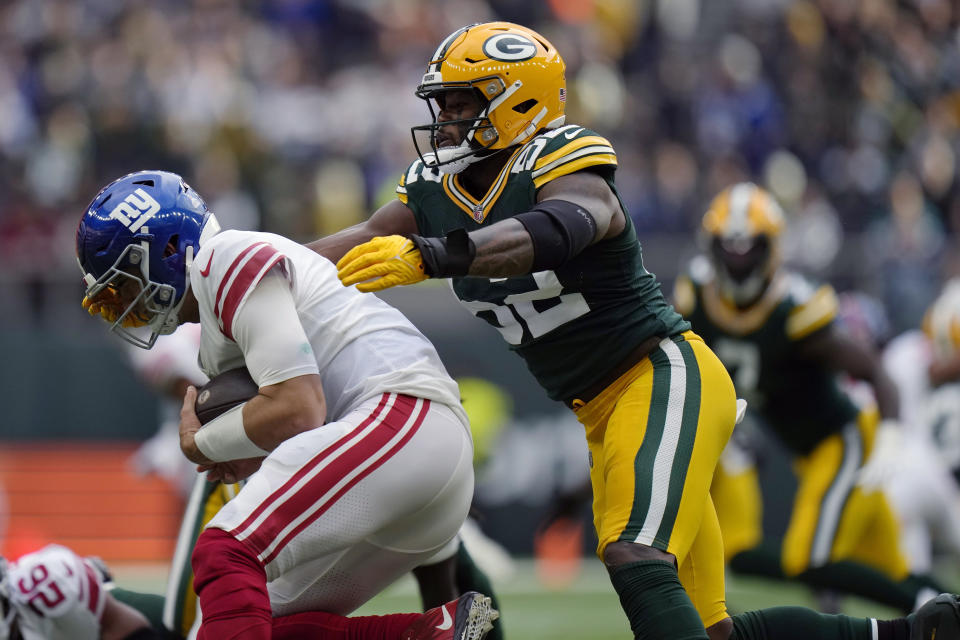 FILE - Green Bay Packers linebacker Rashan Gary (52) sacks New York Giants quarterback Daniel Jones during the second half of an NFL football game in London, Oct. 9, 2022. Gary isn’t making any predictions regarding just when he might return to action after a torn anterior cruciate ligament ended his 2022 season prematurely. “I'll be ready when I'll be ready,” Gary said Wednesday, June 14, while talking to reporters for the first time since injuring his right knee last November. (AP Photo/Alastair Grant, File)