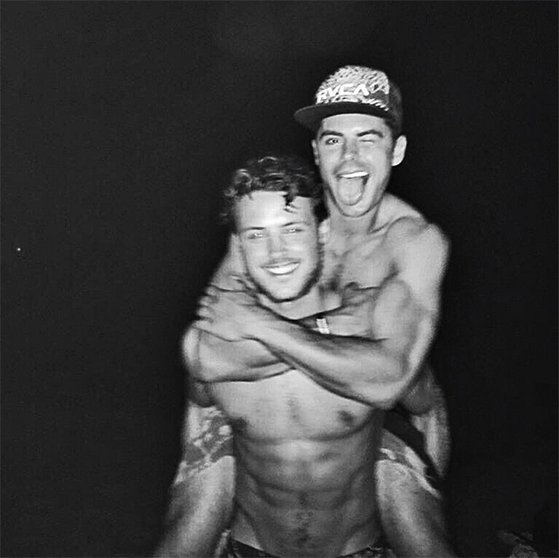 <p>And in more B/W photos, this is Zac Efron with his brother Dylan who — and I think I speak for us all at this point — should also be given a role in this new <em>Baywatch</em> movie. </p>