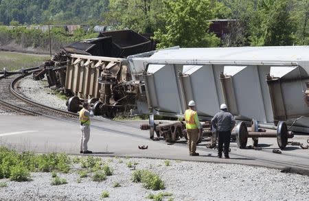 Investigators survey a freight train derailment involving at least 10 cars which left the tracks in Pittsburgh, Pennsylvania May 14, 2015. REUTERS/John Altdorfer