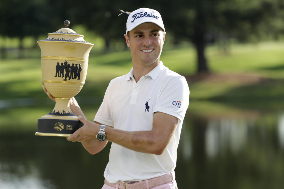 Justin Thomas holds the trophy after winning the World Golf Championship-FedEx St. Jude Invitational Sunday, Aug. 2, 2020, in Memphis, Tenn. (AP Photo/Mark Humphrey)