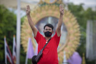 A Pro-democracy supporter displays the three-finger symbol of resistanc, during a demonstration in Bangkok, Thailand, Thursday, June 24, 2021. Pro-democracy demonstrators have taken to the streets of Thailand's capital again, marking the 89th anniversary of the overthrow of the country's absolute monarchy by renewing their demands that the government step down, the constitution be amended and the monarchy become more accountable. (AP Photo/Wason Wanichakorn)