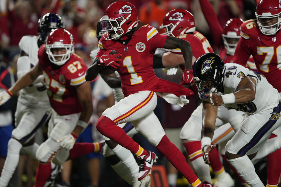 Kansas City Chiefs wide receiver Xavier Worthy (1) scores past Baltimore Ravens linebacker Malik Harrison (40) during the first half of an NFL football game on Thursday, Sept. 5, 2024, in Kansas City, Missouri. (AP Photo/Charlie Riedel)