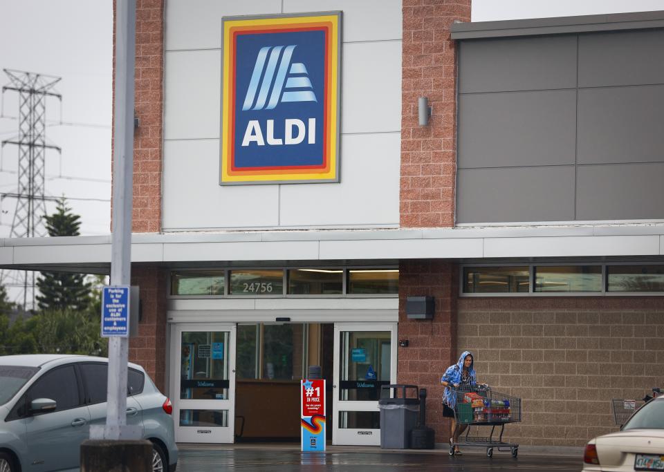 An shopper leaves an ALDI store Wednesday, Aug. 16, 2023 in Clearwater, Fla.. Discount grocer Aldi said Wednesday it plans to buy 400 Winn-Dixie and Harveys supermarkets in the southern U.S. (Chris Urso/Tampa Bay Times via AP)