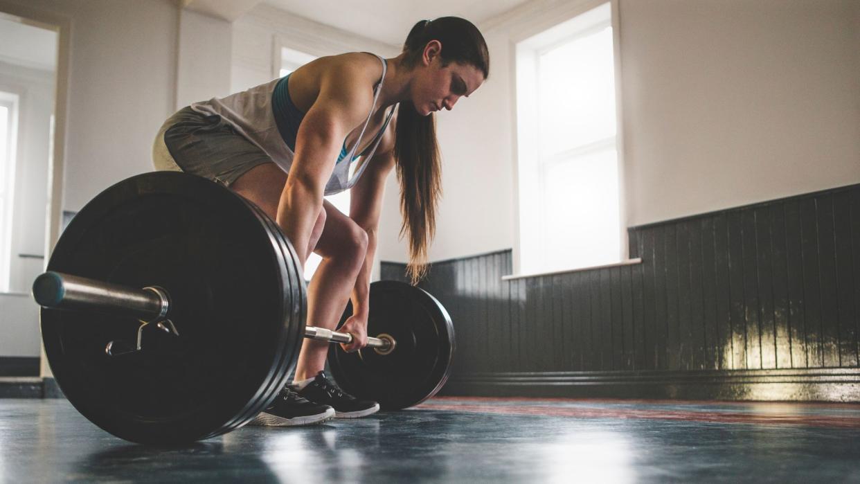  Woman performing a conventional deadlift. 