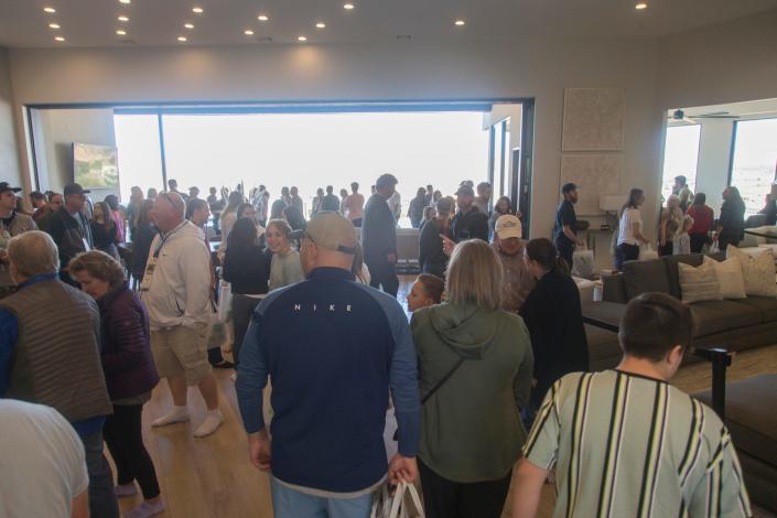 People wander through Eminence in Stone Cliff during the annual Parade of Homes Saturday, Feb. 19, 2022.