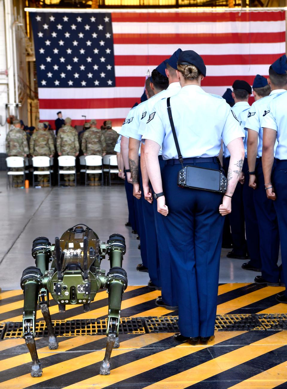 Cerberus, a QUGB or Quadruped Unattended Ground Vehicle, stands in formation beside Sg. Rachel Corke during Monday’s change of command ceremony.