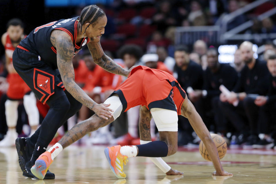 Houston Rockets guard Jalen Green, right, goes down after getting hip checked for a flagrant foul by Chicago Bulls forward DeMar DeRozan, left, during the second half of an NBA basketball game Thursday, March 21, 2024, in Houston. An ensuing scuffle after the foul between DeRozan and Rockets forward Dillon Brooks resulted in both being ejected. (AP Photo/Michael Wyke)