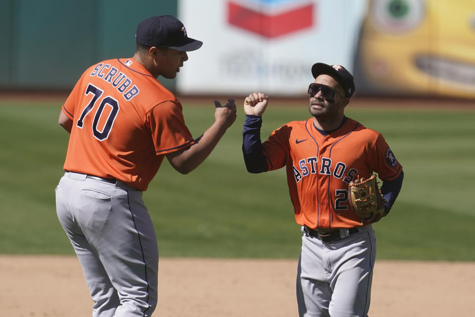 Houston Astros pitcher Andre Scrubb (70) celebrates with second baseman Jose Altuve after the Astros defeated the Oakland Athletics 8-4 in a baseball game in Oakland, Calif., Thursday, May 20, 2021. (AP Photo/Jeff Chiu)