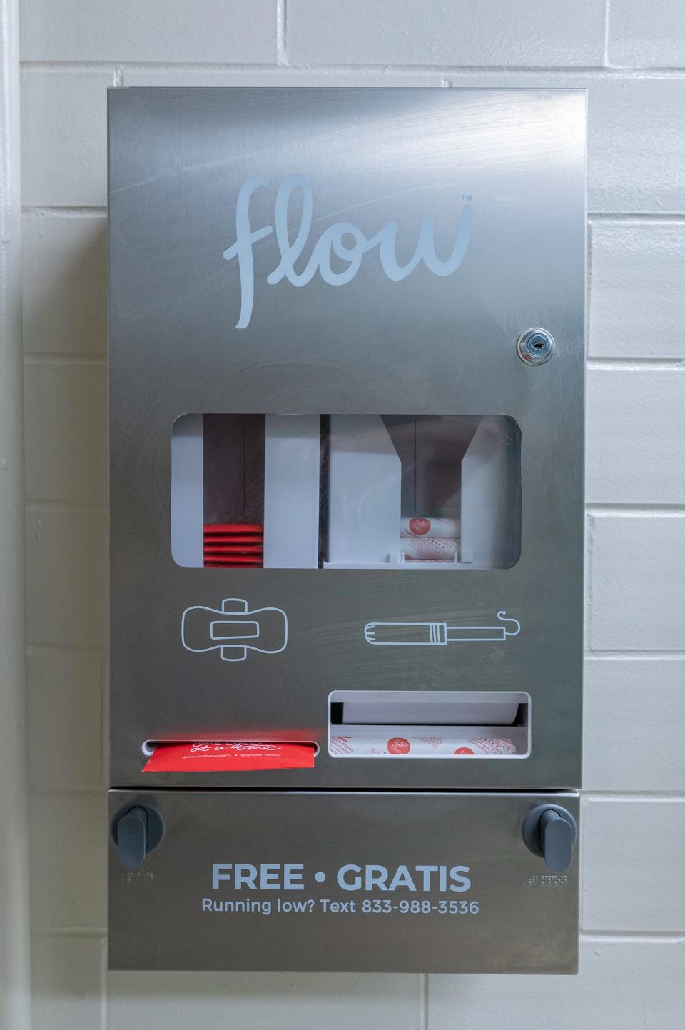 A machine dispensing free pads and tampons is shown at a restroom in a high school in Pueblo, Colorado, after an initiative led by students there.