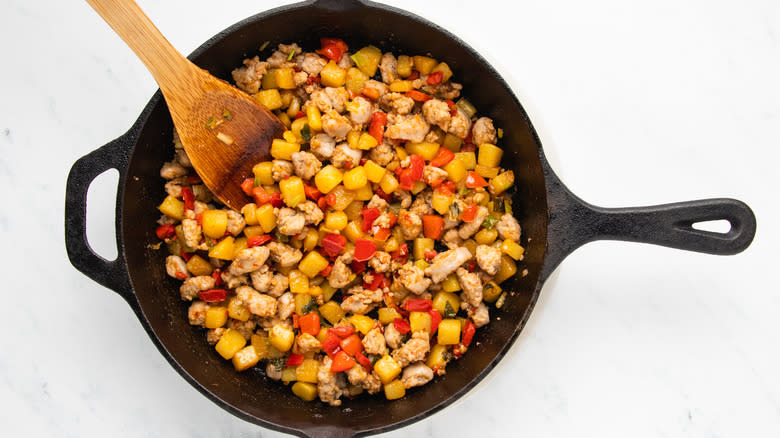 sausage and veg cooking in skillet