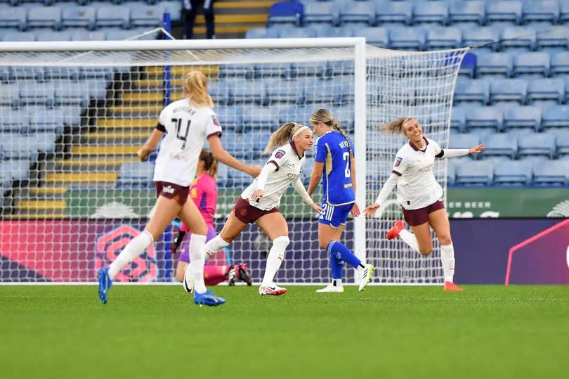 Chloe Kelly runs away from goal with her arms out celebrating