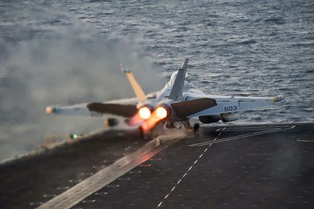 An EA-18G Growler launches from the Nimitz-class aircraft carrier USS Carl Vinson (CVN 70) in this U.S. Navy picture taken in the Arabian Gulf October 28, 2014. REUTERS/U.S. Navy/Mass Communication Specialist 2nd Class John Philip Wagner Jr./Handout via Reuters/Files