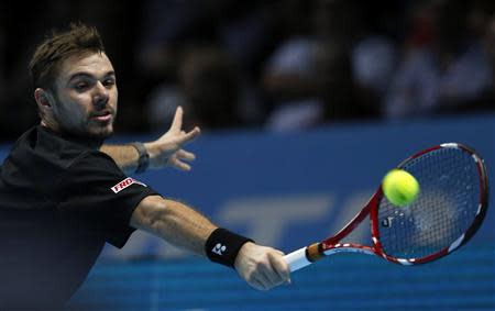 Stanislas Wawrinka of Switzerland hits a return during his men's singles tennis match against Rafael Nadal of Spain at the ATP World Tour Finals at the O2 Arena in London November 6, 2013. REUTERS/Suzanne Plunkett