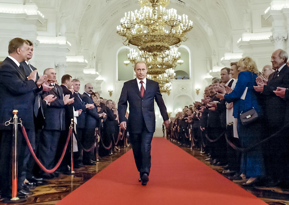 FILE - Russian President Vladimir Putin walks through St. George's Hall to take part in an inauguration ceremony in Moscow's Kremlin, Russia on May 7, 2004. Putin is elected to a second presidential term. (AP Photo/Alexander Zemlianichenko, Pool, File)