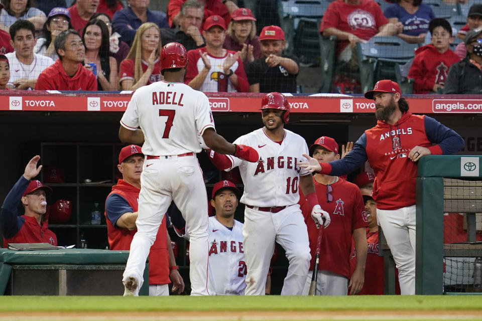 Los Angeles Angels' Jo Adell (7) returns to the dugout after scoring off of a ground rule double hit by Max Stassi during the third inning of a baseball game against the Boston Red Sox in Anaheim, Calif., Tuesday, June 7, 2022. (AP Photo/Ashley Landis)