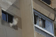 Smoke from a sniper's bullet rises targeting a Christian's house, after deadly clashes erupted along a former 1975-90 civil war front-line between Muslim Shiite and Christian areas, in Ain el-Remaneh neighborhood, Beirut, Lebanon, Thursday, Oct. 14, 2021. Lebanon's interior minister said at least five people have been killed in armed clashes in Beirut that erupted Thursday during protests against the lead investigator into last year's massive blast at the city's port. (AP Photo/Hussein Malla)