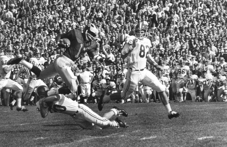 Michigan defensive back George Hoey, shown here against Michigan State, delivered the decisive punt return to give the Wolverines their 500th victory as a program in 1967.