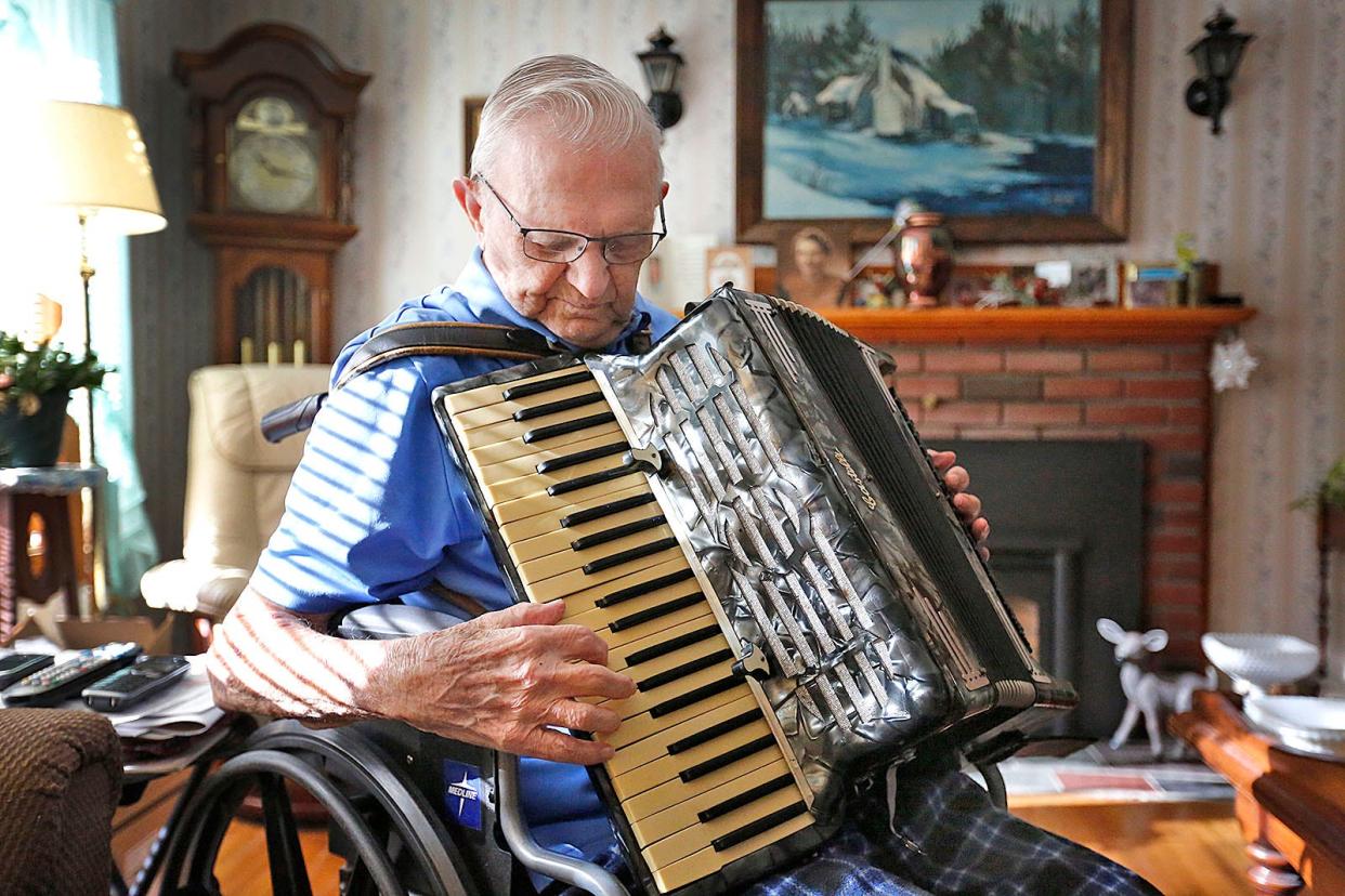 Tom played all sorts of music in his life. He is shown here playing an accordion that belonged to his mother and is 100 years old.