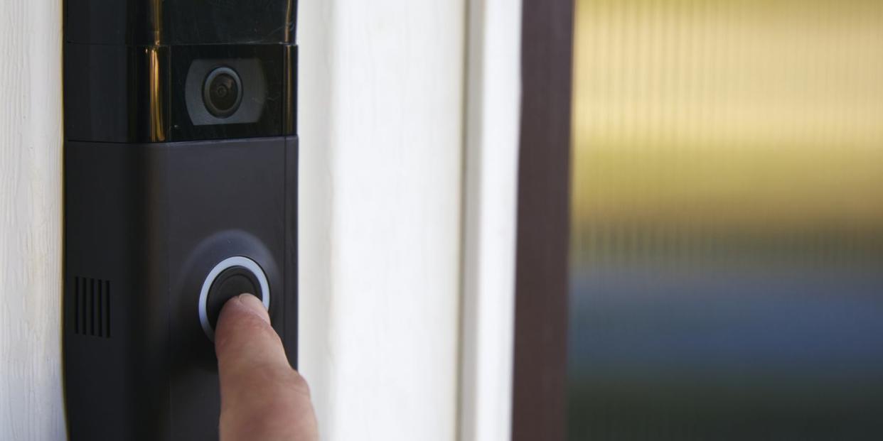 close up pov shot of a person ringing a smart doorbell
