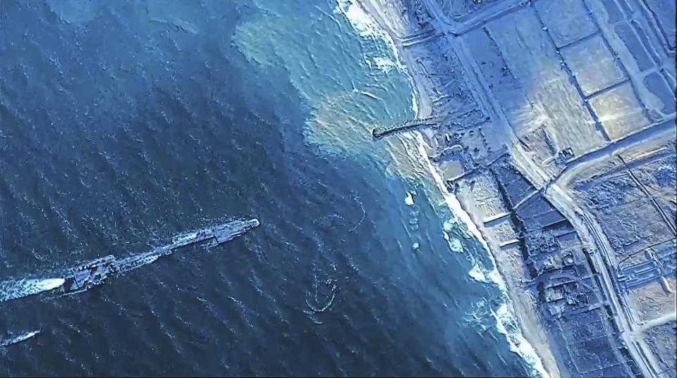 The image provided by U.S, Central Command, shows U.S. Army soldiers assigned to the 7th Transportation Brigade (Expeditionary), U.S. Navy sailors assigned to Amphibious Construction Battalion 1, and Israel Defense Forces placing the Trident Pier on the coast of Gaza Strip on Thursday, May 16, 2024. The temporary pier is part of the Joint Logistics Over-the-Shore capability. The U.S. military finished installing the floating pier on Thursday, with officials poised to begin ferrying badly needed humanitarian aid into the enclave besieged over seven months of intense fighting in the Israel-Hamas war. (U.S. Central Command via AP)