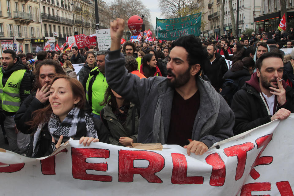 Protesters march during a demonstration Thursday, Dec. 19, 2019 in Paris. Traffic improved slightly on French trains Thursday as nationwide strikes over the government's retirement reform entered a 15th day and small signs of progress emerged in negotiations with unions. (AP Photo/Michel Euler)