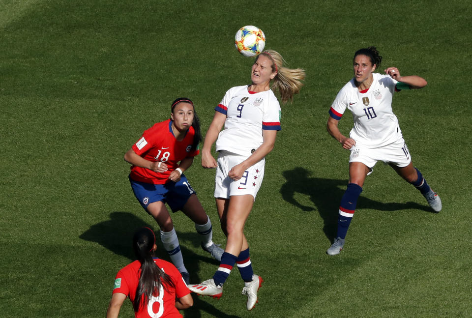 United States' Lindsey Horan, center, heads the ball during the Women's World Cup Group F soccer match between the United States and Chile at the Parc des Princes in Paris, Sunday, June 16, 2019. (AP Photo/Thibault Camus)