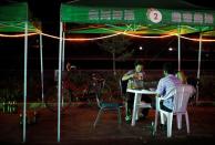 FILE PHOTO: A North Korean woman drinks beer at a local market in Rajin at the Special Economic Zone of Rason City, northeast of Pyongyang